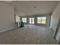 Open concept living room with tile floors and access to the outdoors at 8347 Ada St, Port Charlotte, FL 33981