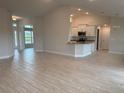 Open-concept living area with vaulted ceilings, tile floors, and plenty of natural light throughout the house at 8347 Ada St, Port Charlotte, FL 33981