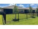 Private backyard with a black metal fence at 25168 E Lenox Cir, Punta Gorda, FL 33950