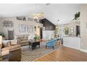 Open concept living room with hardwood floors and a view into the kitchen at 22058 Seaton Ave, Port Charlotte, FL 33954