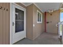 Condo entry with white door and screen, adjacent to building exterior at 150 Harborside Ave # 216, Punta Gorda, FL 33950