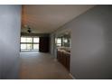 Living room with view of patio and wet bar at 255 Mission S Trl # J, Venice, FL 34285