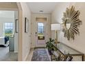 Bright entryway with decorative mirror and view to backyard at 1817 W Price Blvd, North Port, FL 34286