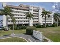 Condo building with palm trees and waterfront views at 1500 Park Beach Cir # 4A, Punta Gorda, FL 33950