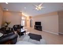 Living room with tile flooring and dark couches at 552 Rose Apple Cir, Port Charlotte, FL 33954