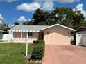 Front view of a charming ranch home with a spacious yard at 829 Pineland Ave, Venice, FL 34285
