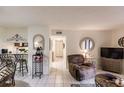 Spacious living room with recliner, TV, and view to kitchen at 1515 Forrest Nelson Blvd # H108, Port Charlotte, FL 33952
