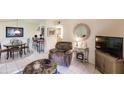 Bright living room features a comfy recliner and dining area at 1515 Forrest Nelson Blvd # H108, Port Charlotte, FL 33952