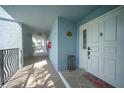 Light-filled hallway with white door and access to balcony at 1750 Jamaica Way # 112 Bld 1, Punta Gorda, FL 33950