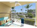 Relaxing screened porch with a swing and view of the community at 2002 Bal Harbor Blvd # 312, Punta Gorda, FL 33950