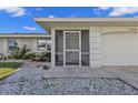Inviting front porch and well maintained exterior, landscaped with decorative rocks and a lush garden at 17341 Sabrina Cir, Port Charlotte, FL 33948