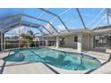 Enjoy Florida living with a beautiful pool, screened-in lanai, and a spacious outdoor area at 17341 Sabrina Cir, Port Charlotte, FL 33948
