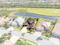 An aerial view of a luxurious property with a tile roof, landscaped yard, and pond views at 5241 Grand Palmetto Way, North Port, FL 34291