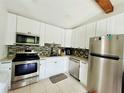 Renovated kitchen featuring stainless steel appliances and white shaker cabinets at 14300 Worthwhile Rd, Port Charlotte, FL 33953