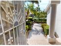 Walkway leading to the home with lush landscaping at 3800 Bal Harbor Blvd # 214, Punta Gorda, FL 33950