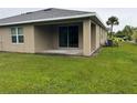 Spacious backyard with covered patio and grassy area at 7633 W Lenox Cir, Punta Gorda, FL 33950
