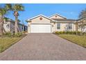 Two-car garage and manicured landscaping at 1530 Laurel Brook Ln, Port Charlotte, FL 33953