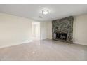Living room featuring a stone fireplace and tile flooring at 2624 Lee St, Punta Gorda, FL 33950