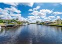 Scenic view of a residential canal with boats and lush landscaping at 3730 Turtle Dove Blvd, Punta Gorda, FL 33950