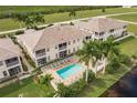 Aerial view of a community with a pool and lush landscaping at 17084 Acapulco Rd # 222, Punta Gorda, FL 33955