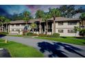 Two-story building with palm trees and landscaped grounds at 1515 Forrest Nelson Blvd # G102, Port Charlotte, FL 33952