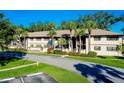 Two-story building with palm trees and landscaped grounds at 1515 Forrest Nelson Blvd # G102, Port Charlotte, FL 33952