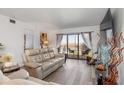 Spacious living room with light beige reclining sofas and water views at 175 Kings Hwy # B6-526, Punta Gorda, FL 33983