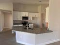 Modern kitchen featuring granite countertops and stainless steel appliances at 14326 Edsel Dr, Port Charlotte, FL 33981