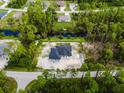 Aerial view of a new construction home on a wooded lot at 2502 Pinewood St, North Port, FL 34288