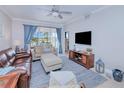 Comfortable living room featuring leather sofas and a large TV at 3228 Purple Martin Dr # 113, Punta Gorda, FL 33950
