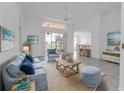 Spacious living room with light blue sofa and access to backyard at 24083 Buckingham Way, Port Charlotte, FL 33980