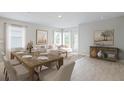 Bright dining area with a wooden table and chairs, hardwood floors, and large windows at 107 Santarem Cir, Punta Gorda, FL 33983