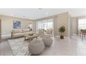 Bright living room features stylish furnishings, a neutral color palette, and sliding glass doors to the lanai at 25228 Rampart Blvd, Punta Gorda, FL 33983