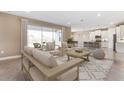 Open concept living area flows into the kitchen with modern island, and stainless appliances at 25228 Rampart Blvd, Punta Gorda, FL 33983