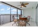 Spacious balcony with glass-top table and chairs, offering scenic water views at 9011 Midnight Pass Rd # 329, Sarasota, FL 34242