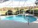 Relaxing pool and spa with screened enclosure at 13744 Long Lake Ln, Port Charlotte, FL 33953