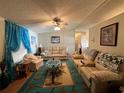 Spacious living room featuring comfy sofas and a large area rug at 707 Riverview Cir, North Port, FL 34287