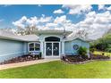 Front view of a light blue house with decorative gate at 1024 Inverness St, Port Charlotte, FL 33952