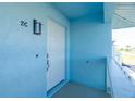 White front door with light fixture, located on a light blue building exterior at 2735 Magdalina Dr # 2C, Punta Gorda, FL 33950