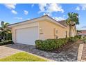 Single-car garage with a paved driveway and neat landscaping at 3743 Albacete Cir # 84, Punta Gorda, FL 33950