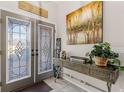 Bright entryway with decorative console table and double doors at 7417 S Blue Sage, Punta Gorda, FL 33955