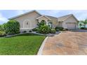 Landscaped front yard with stamped concrete driveway at 7417 S Blue Sage, Punta Gorda, FL 33955