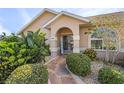 Front entry with stone walkway, landscaping, and double doors at 7417 S Blue Sage, Punta Gorda, FL 33955