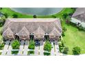 Three attached townhomes viewed from above showcasing rooflines and landscaping at 20149 Lagente Cir, Venice, FL 34293