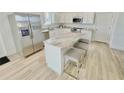 Modern kitchen featuring a large island with seating and stainless steel appliances at 3140 Sweet Gum Dr, Punta Gorda, FL 33982