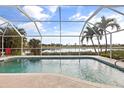 Relaxing pool and patio area with golf course view at 4077 La Costa Island Ct, Punta Gorda, FL 33950