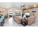 Spacious living room with lake view and wood-look tile at 4077 La Costa Island Ct, Punta Gorda, FL 33950