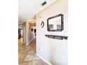 Bright hallway with tiled floors and modern wall decor at 509 Clearview Dr, Port Charlotte, FL 33953