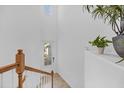 Open staircase with wood railing and gray carpeting at 14640 Sycamore Ct # 2822, Punta Gorda, FL 33955