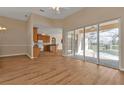 Living room with kitchen and pool views, laminate floors, and neutral colors at 2262 Rio De Janeiro Ave, Punta Gorda, FL 33983